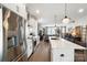 Modern kitchen showcasing stainless steel appliances and open layout to living space at 7020 Loso Commons Way, Charlotte, NC 28217