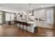 A modern kitchen featuring a large island, pendant lighting, and dining area at 7020 Loso Commons Way, Charlotte, NC 28217