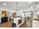 Bright kitchen with a large island, stainless steel appliances, and wood floors at 7020 Loso Commons Way, Charlotte, NC 28217