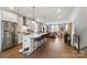Bright, open kitchen with a large island, modern appliances, and hardwood floors at 7020 Loso Commons Way, Charlotte, NC 28217
