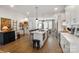 Bright kitchen with a large island, stainless steel appliances, and wood floors at 7020 Loso Commons Way, Charlotte, NC 28217