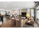 Spacious open-concept living room seamlessly flows into a modern kitchen with hardwood floors and stylish decor at 7020 Loso Commons Way, Charlotte, NC 28217