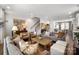 Open-concept living room showcasing stylish furniture, elegant decor, and seamless flow to the kitchen at 7020 Loso Commons Way, Charlotte, NC 28217