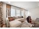 Bright living room features a comfortable sectional sofa, plush pillows, and a modern workstation at 7020 Loso Commons Way, Charlotte, NC 28217