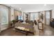 Bright and airy living room featuring hardwood floors, neutral tones, and an abundance of natural light at 7020 Loso Commons Way, Charlotte, NC 28217