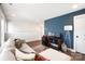 Stylish living room featuring a navy accent wall, modern lamp, workstation and comfortable sectional sofa at 7020 Loso Commons Way, Charlotte, NC 28217