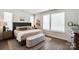 Calm main bedroom featuring natural light from large windows, neutral walls, and stylish decor at 7020 Loso Commons Way, Charlotte, NC 28217
