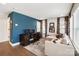 Comfortable office with a blue accent wall, sofa, desk and hardwood floors at 7020 Loso Commons Way, Charlotte, NC 28217