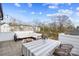 Enjoy outdoor living with a dining table, wicker chairs, comfortable sofa, and string lights at 7020 Loso Commons Way, Charlotte, NC 28217