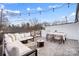 Outdoor rooftop terrace with a dining table, wicker chairs, comfortable sofa and a fire pit at 7020 Loso Commons Way, Charlotte, NC 28217