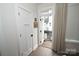 View of the powder room door and open porch door that shows the exterior at 7020 Loso Commons Way, Charlotte, NC 28217