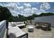 Outdoor roof deck featuring comfortable seating, string lights, and a dining area, perfect for entertaining at 7020 Loso Commons Way, Charlotte, NC 28217