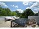 Stylish outdoor roof deck featuring dining furniture, comfortable seating, and greenery in the background at 7020 Loso Commons Way, Charlotte, NC 28217