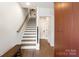 Open staircase with wood steps and modern lighting at 7020 Loso Commons Way, Charlotte, NC 28217