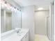 Bright bathroom with a vanity, modern lighting, and a separate shower area at 7719 Abigail Glen Dr, Charlotte, NC 28212