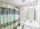 Bathroom featuring a shower with curtain, white toilet and vanity sink at 7719 Abigail Glen Dr, Charlotte, NC 28212