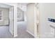 Open bedroom view with a ceiling fan, window and plush gray carpet at 7719 Abigail Glen Dr, Charlotte, NC 28212