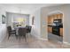 Chic dining room featuring a modern table set and a window that floods the space with natural light at 7719 Abigail Glen Dr, Charlotte, NC 28212