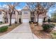 Charming townhome featuring a one-car garage, driveway, and well-maintained landscaping at 7719 Abigail Glen Dr, Charlotte, NC 28212
