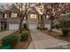 Charming townhome featuring a one-car garage, driveway, and well-maintained landscaping at 7719 Abigail Glen Dr, Charlotte, NC 28212
