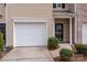 Close-up of the townhome's one-car garage and front entry at 7719 Abigail Glen Dr, Charlotte, NC 28212