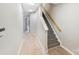 Hallway view highlighting wood-look floors and a staircase with carpeted steps at 7719 Abigail Glen Dr, Charlotte, NC 28212