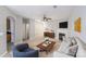 Bright living room with fireplace, modern furniture, and an open floor plan exudes a cozy, stylish ambiance at 7719 Abigail Glen Dr, Charlotte, NC 28212