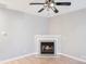 Well-lit living room featuring a fireplace and ceiling fan at 7719 Abigail Glen Dr, Charlotte, NC 28212