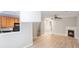 Spacious open-concept living room features a fireplace, ceiling fan and wood flooring at 7719 Abigail Glen Dr, Charlotte, NC 28212