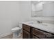 Clean bathroom, featuring dark brown vanity and white toilet at 821 Hallman Branch Ln, Lincolnton, NC 28092