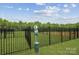 Community dog park featuring black fencing, dog waste station, and ample green space for pets to roam at 821 Hallman Branch Ln, Lincolnton, NC 28092
