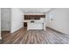 Modern kitchen with island and dark brown cabinets at 821 Hallman Branch Ln, Lincolnton, NC 28092