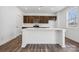 Modern kitchen with island and dark brown cabinets at 821 Hallman Branch Ln, Lincolnton, NC 28092