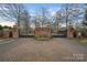 Elegant gated community entrance with brick pillars, ornate gates, and landscaped median at 8908 Heydon Hall Cir, Charlotte, NC 28210