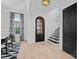 Elegant foyer featuring a stylish front door, staircase, hardwood floors, and modern decor at 8908 Heydon Hall Cir, Charlotte, NC 28210