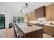 Modern kitchen featuring a large center island with seating, marble countertops, custom cabinetry, and stainless steel appliances at 8908 Heydon Hall Cir, Charlotte, NC 28210