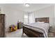 Cozy bedroom featuring a wood-frame bed, natural light, and neutral-colored walls at 912 Harbor Islands Ct, Gastonia, NC 28056