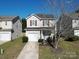 Two-story home with a front lawn, driveway, and classic architectural details at 10302 Hugue Way, Charlotte, NC 28214