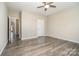 Bedroom with wood-look floors, ceiling fan, and neutral paint at 104 Postell Dr, Statesville, NC 28625