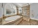 Spa-like bathroom with soaking tub, walk-in shower, and large window at 10811 Old Tayport Pl, Charlotte, NC 28277