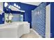 Bathroom with blue walls, white vanity, and tiled shower at 10811 Old Tayport Pl, Charlotte, NC 28277