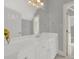 Well-lit bathroom with white vanity, tile flooring, and a large mirror at 10811 Old Tayport Pl, Charlotte, NC 28277