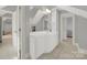 Clean bathroom with white vanity, tile flooring, and a large mirror at 10811 Old Tayport Pl, Charlotte, NC 28277