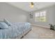 Light and airy bedroom with window and ceiling fan at 10811 Old Tayport Pl, Charlotte, NC 28277