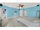 Bedroom with ceiling fan, light blue walls, and ensuite bathroom at 10811 Old Tayport Pl, Charlotte, NC 28277