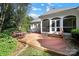 Large deck with hot tub and surrounding landscaping at 10811 Old Tayport Pl, Charlotte, NC 28277