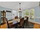 Formal dining room with dark wood table and chairs and arched windows at 10811 Old Tayport Pl, Charlotte, NC 28277