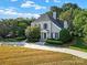 Two-story house with gray siding, gray roof, and landscaping at 10811 Old Tayport Pl, Charlotte, NC 28277