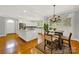 Modern kitchen with white cabinets, large island, and stainless steel appliances at 10811 Old Tayport Pl, Charlotte, NC 28277