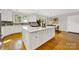 Updated kitchen with white cabinets, large island, and breakfast bar at 10811 Old Tayport Pl, Charlotte, NC 28277
